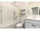 Bright bathroom boasting a white vanity with a mirror, a toilet, and a shower-tub combo at 2256 W Laurie Ln, Phoenix, AZ 85021