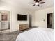 Light-filled bedroom with en-suite bathroom, ceiling fan, TV, dresser, and cozy carpet at 2256 W Laurie Ln, Phoenix, AZ 85021