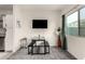 Cozy dining area with a table, TV, and a large window with curtains at 2256 W Laurie Ln, Phoenix, AZ 85021