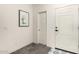 Bright entryway featuring white walls, decorative tile, and a cactus-themed picture at 2256 W Laurie Ln, Phoenix, AZ 85021