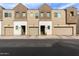 Row of modern townhomes with garages and desert landscaping add curb appeal at 2256 W Laurie Ln, Phoenix, AZ 85021