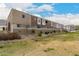 Modern townhome showcasing neutral colors, with a manicured lawn and green space in front, beautiful landscaping at 2256 W Laurie Ln, Phoenix, AZ 85021