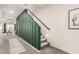 Hallway with staircase, view into a cozy living room and green accent wall at 2256 W Laurie Ln, Phoenix, AZ 85021