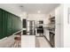 Modern kitchen featuring white cabinets, stainless steel appliances, granite countertops, and a functional island at 2256 W Laurie Ln, Phoenix, AZ 85021