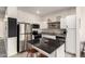 Updated kitchen featuring white cabinets, stainless steel appliances, and a functional island with barstools in an open layout at 2256 W Laurie Ln, Phoenix, AZ 85021