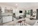 Bright kitchen featuring white cabinets, stainless steel appliances, island with seating, and seamless open layout at 2256 W Laurie Ln, Phoenix, AZ 85021