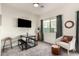 Bright living area with cozy seating, a mounted TV, and an adjacent dining area at 2256 W Laurie Ln, Phoenix, AZ 85021