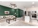 Living room boasts green accent wall, ceiling fan, and view of an adjacent kitchen at 2256 W Laurie Ln, Phoenix, AZ 85021
