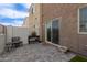 Private patio area with chairs, table, potted plants, and a sliding door to the home at 2256 W Laurie Ln, Phoenix, AZ 85021