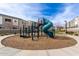 Community playground with a blue slide, monkey bars, and a wood chip safety surface in a well-maintained setting at 2256 W Laurie Ln, Phoenix, AZ 85021