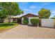 Manicured backyard with gravel landscaping, green grass, a storage shed and mature trees offering ample space and privacy at 2264 S Don Carlos --, Mesa, AZ 85202