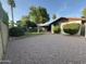 Spacious backyard with a gravel area and lush green lawn offering ample space for outdoor activities and entertaining at 2264 S Don Carlos --, Mesa, AZ 85202