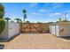 Spacious backyard featuring a wooden gate, two storage sheds and gravel creating the perfect outdoor area at 2264 S Don Carlos --, Mesa, AZ 85202