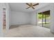 Bedroom featuring a ceiling fan, a sliding door, and neutral carpeting at 2264 S Don Carlos --, Mesa, AZ 85202