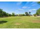 Expansive grassy park featuring open space, mature trees, and playground equipment at 2264 S Don Carlos --, Mesa, AZ 85202