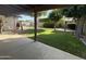 View from the covered patio overlooking a well-maintained backyard with a lawn, mature trees, and a gazebo at 2264 S Don Carlos --, Mesa, AZ 85202