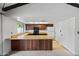 View of kitchen with wooden cabinets, a center island, and all-white appliances at 2264 S Don Carlos --, Mesa, AZ 85202