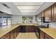 Bright kitchen featuring wood cabinets, laminate countertops, and a garden view at 2264 S Don Carlos --, Mesa, AZ 85202