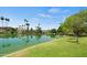 Picturesque waterfront homes with palm trees line a tranquil lake, offering stunning views and a serene setting at 2264 S Don Carlos --, Mesa, AZ 85202