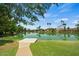 Scenic lake view with waterfront homes surrounded by lush landscaping and palm trees at 2264 S Don Carlos --, Mesa, AZ 85202