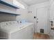 Clean laundry room with shelving, washer, dryer, and access to the outdoors at 2264 S Don Carlos --, Mesa, AZ 85202