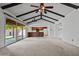 Large living space features vaulted ceilings, sliding glass doors, and kitchen access at 2264 S Don Carlos --, Mesa, AZ 85202
