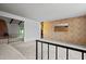 Spacious living room with neutral carpet flooring, fireplace, and railing at 2264 S Don Carlos --, Mesa, AZ 85202