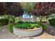 Laguna Park entrance sign with lush greenery, flowers, and trees creating a welcoming atmosphere at 2264 S Don Carlos --, Mesa, AZ 85202