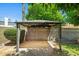 A covered patio is set against a block wall with green foliage visible in the background at 2264 S Don Carlos --, Mesa, AZ 85202