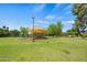 A playground with swings and climbing structures sits under a sunshade canopy in the park at 2264 S Don Carlos --, Mesa, AZ 85202