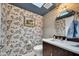 Charming powder room with floral wallpaper, modern fixtures, and a round mirror, blending style and functionality at 3109 E Sierra Madre Way, Phoenix, AZ 85016