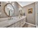 Stunning bathroom with double sinks, decorative mirrors, and patterned wallpaper that adds a touch of elegance at 3109 E Sierra Madre Way, Phoenix, AZ 85016