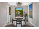 Cozy dining area with a view, featuring modern decor, statement art, and stylish lighting at 3109 E Sierra Madre Way, Phoenix, AZ 85016