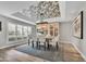 Chic dining room featuring a decorative ceiling, modern chandelier, and sleek wood flooring at 3109 E Sierra Madre Way, Phoenix, AZ 85016