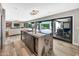 Open concept kitchen with an island, wine fridge, and sliding glass doors leading to the outdoor area at 3109 E Sierra Madre Way, Phoenix, AZ 85016
