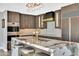 Modern kitchen featuring a marble island, gold fixtures, and custom wood cabinetry at 3109 E Sierra Madre Way, Phoenix, AZ 85016