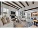 Bright living room showcasing exposed wood beams, a fireplace, and elegant, neutral-toned furniture at 3109 E Sierra Madre Way, Phoenix, AZ 85016