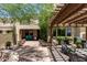 Lush backyard with patio, pergola, and plenty of pots for flowers for a beautiful look at 3554 N Hooper St, Buckeye, AZ 85396