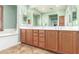 A beautiful bathroom features a long vanity with double sinks and a large mirror at 3554 N Hooper St, Buckeye, AZ 85396