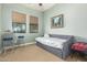 Guest bedroom featuring a daybed, small table, and two windows with shades at 3554 N Hooper St, Buckeye, AZ 85396