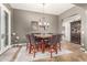 Dining room with a large table, seating for eight, and views to the exterior and kitchen at 3554 N Hooper St, Buckeye, AZ 85396