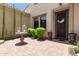 Inviting entryway featuring elegant landscaping, a charming stone table, and a decorative front door at 3554 N Hooper St, Buckeye, AZ 85396