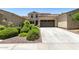 Inviting home featuring a two-car garage, well-kept landscaping, and a classic exterior design at 3554 N Hooper St, Buckeye, AZ 85396