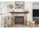 Inviting fireplace with decorative mantle and tiled surround as a focal point at 3554 N Hooper St, Buckeye, AZ 85396