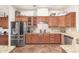 Kitchen with stainless steel refrigerator and appliances, granite countertops, and wooden cabinets at 3554 N Hooper St, Buckeye, AZ 85396