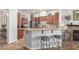 Open kitchen with granite countertops, stainless steel appliances, and breakfast bar with seating at 3554 N Hooper St, Buckeye, AZ 85396