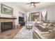 Comfortable living room with fireplace, soft rug, and ample natural light through shuttered windows at 3554 N Hooper St, Buckeye, AZ 85396