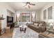 Cozy living area featuring a ceiling fan, plush carpeting, and shuttered windows for natural light at 3554 N Hooper St, Buckeye, AZ 85396
