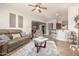 Inviting living room with leather sofa, coffee table, decorative wall hangings, and open access to kitchen at 3554 N Hooper St, Buckeye, AZ 85396