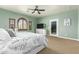 Comfortable main bedroom features plush carpet, private patio access, a ceiling fan, and serene ambiance at 3554 N Hooper St, Buckeye, AZ 85396